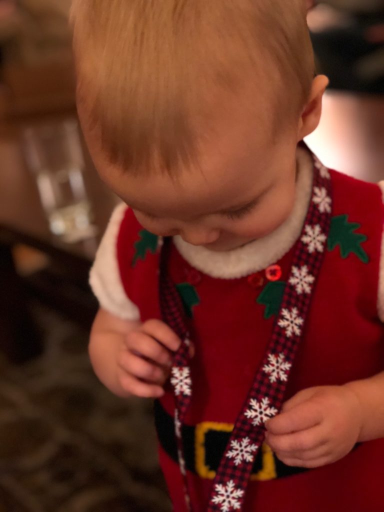 Marcella enjoying ribbon from one of the gifts unwrapped for the yankee swap at our recent family Christmas gathering.