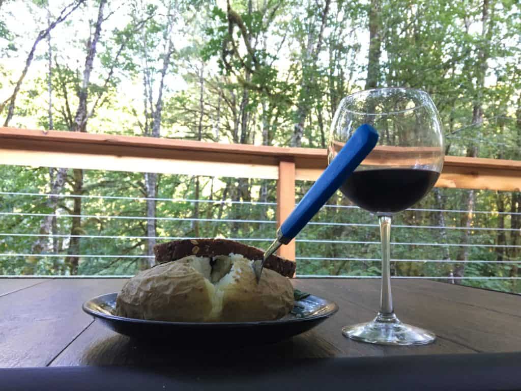 There’s a very tasty veggie burger behind that tasty potato, both heated in the microwave. Plus, wine.
