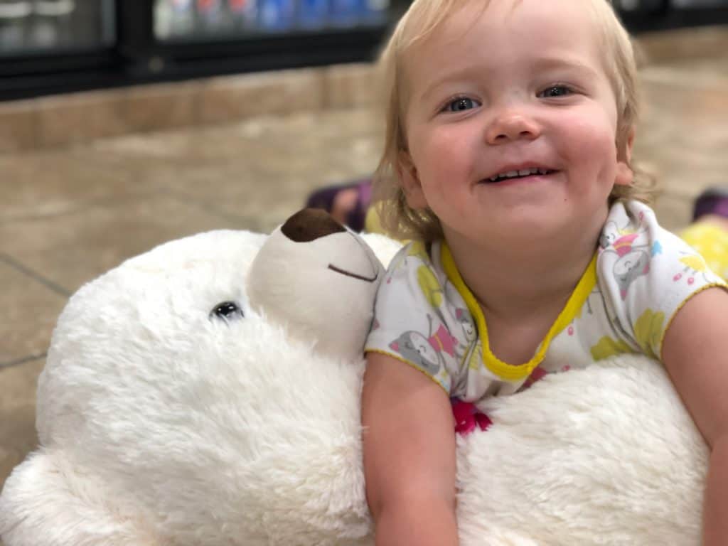 This is Marcella happily playing with a teddy bear... on the filthy floor of a gas station somewhere in Kansas on our way to Missouri. I was appalled and Michael was so pleased.